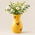 Yellow ceramic vase with butterfly designs 