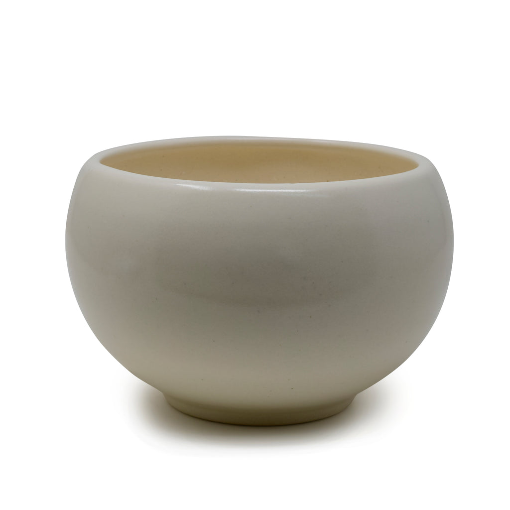 Round ceramic planter pot with drainage hole and smooth bowl-shaped design