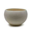Round ceramic planter pot with drainage hole and smooth bowl-shaped design